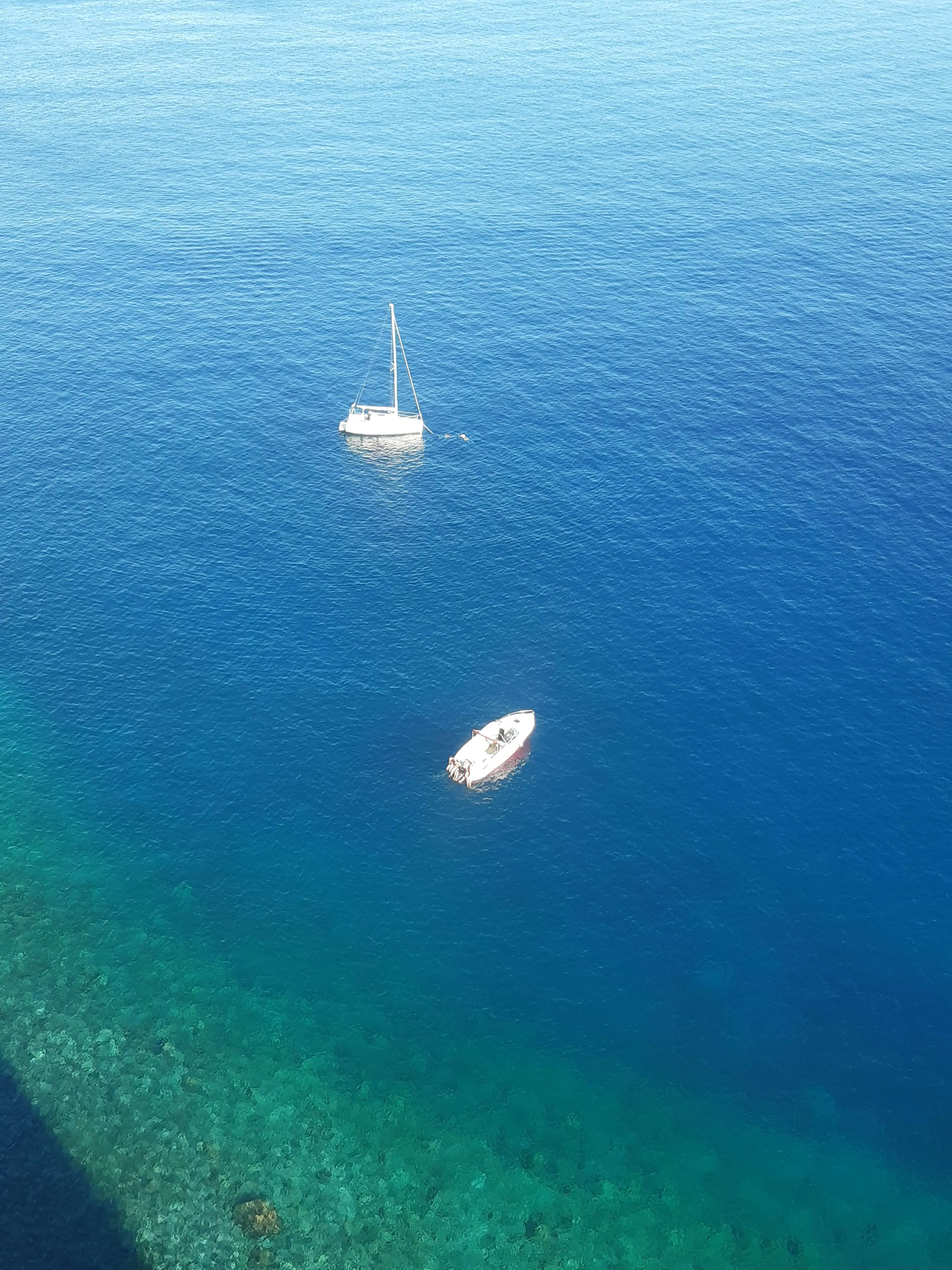Sailing boats on the turquoise Atlantic, from above