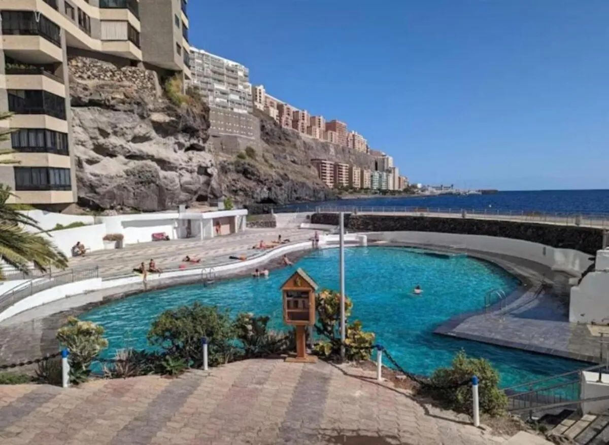 The natural sea pool of Tabaiba, turquoise water below the apartment blocks